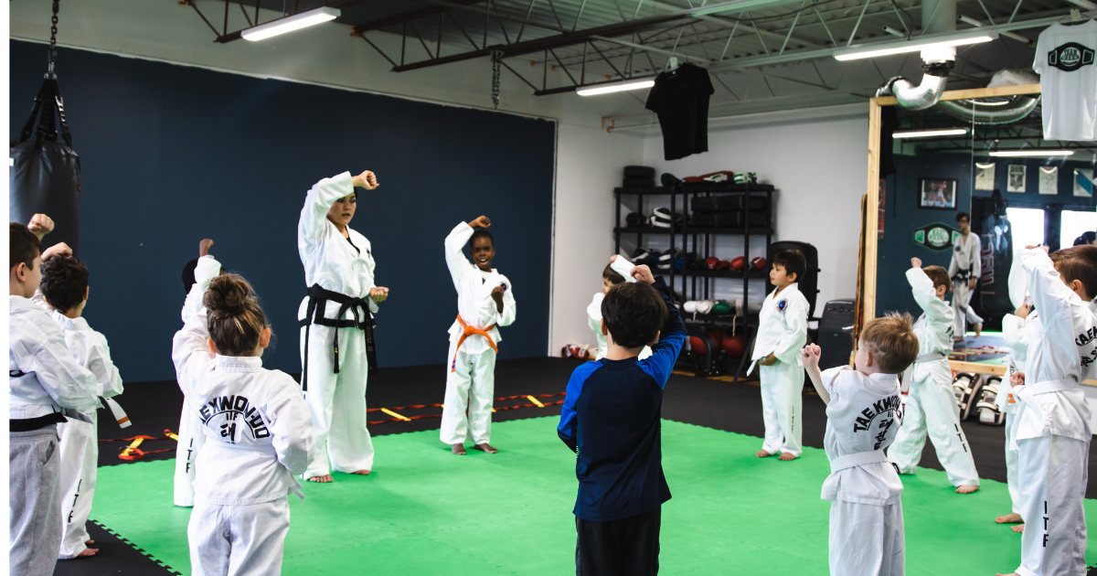 Taekwon-do instructor leading a group of young students at Phoenix Martial Arts summer camp to build focus and confidence for the school year