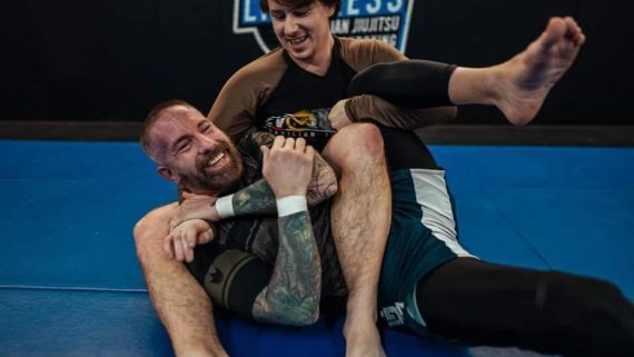 Two Brazilian Jiu-Jitsu students practicing No Gi grappling and positional control while enjoying beginner friendly training.