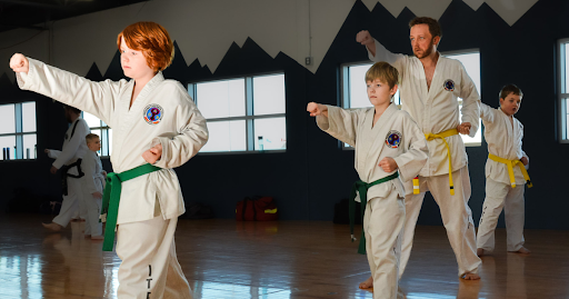 Children practicing Taekwon-do punches for kids personal growth during a Phoenix Martial Arts class