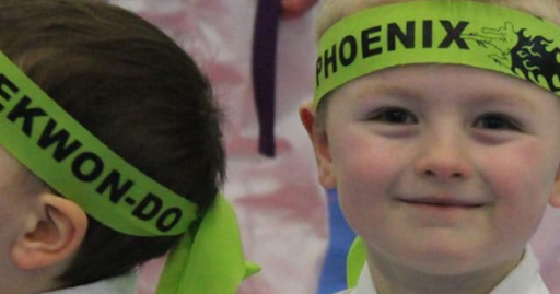 Young Phoenix Martial Arts students during programs for kids wearing Taekwon-Do headbands during a kids summer camp activity in the Edmonton area